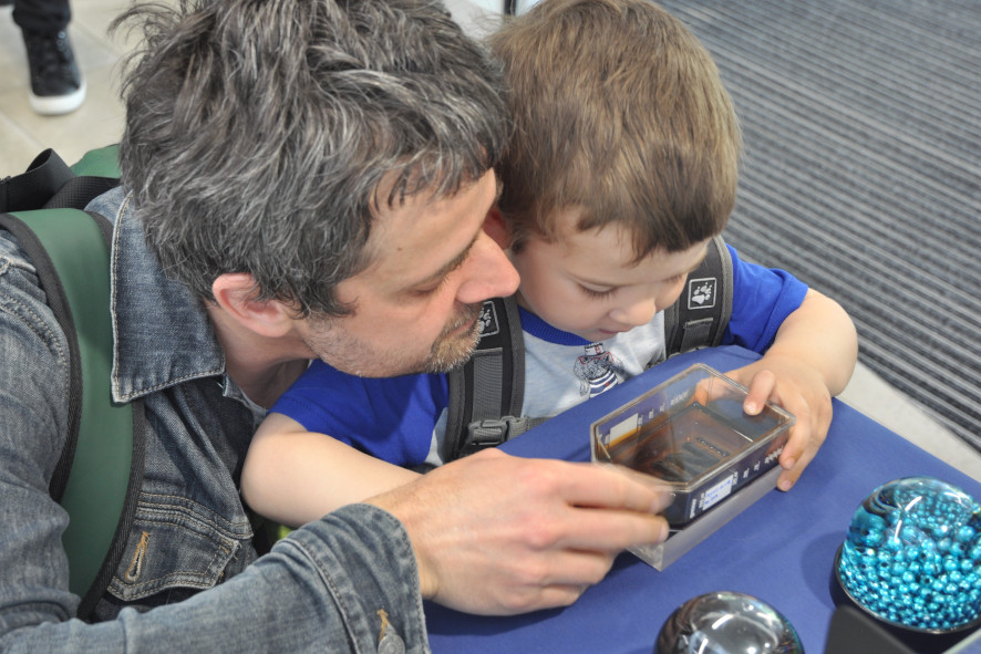 Man and child observe effects of magnetic nanoparticles